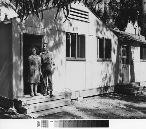 Photograph of woman and teenage boy in front doorway of Keppler Grove unit