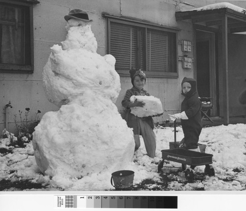 Photograph of children at play in snow at Basilone Homes