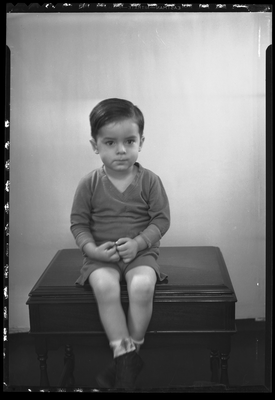 Portrait of a boy sitting on table