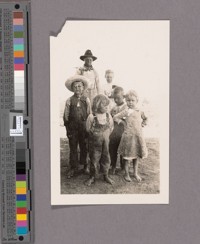 The young man with the ax was "our hired man" and the group of three children were the Hoverly children who lived in an adobe house across the flume from our tent. Ours and the Hoverlys were the only two families living within a mile of other people, excepting the brick makers. The two girls in the picture were Margaret Miller and Elizabeth Miller