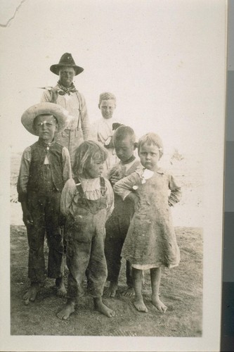 The young man with the ax was "our hired man" and the group of three children were the Hoverly children who lived in an adobe house across the flume from our tent. Ours and the Hoverlys were the only two families living within a mile of other people, excepting the brick makers. The two girls in the picture were Margaret Miller and Elizabeth Miller