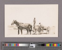 Dr. C.H. Heard driving his team with a wagon filled with goods from his store together with his customer he