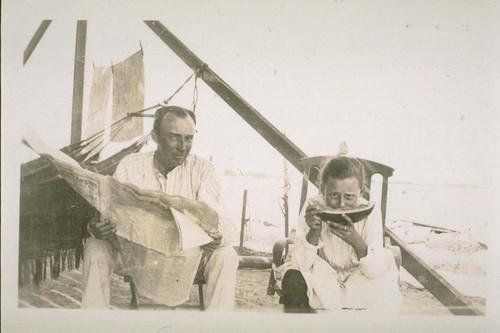 Mr. F.S. Miller and his daughter Margaret eating the first watermellon[sic] grown in Brawley. They are waiting for dinner to