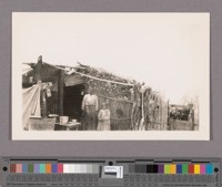 A prosperous appearing family domiciled in Mexicali almost on the line. Her teeth were filled with much gold. On her stove were tortillas cooking and on the ends of the reeds which formed the wells of the residence were empty egg shells. She smilingly consented to have her picture taken while her husband was taking a siesta within