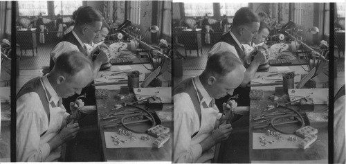 Finishing rings, second man is cutting out pattern for an engagement ring in the "hub" or master for making a die, Jabel Ring Co., Newark, N.J