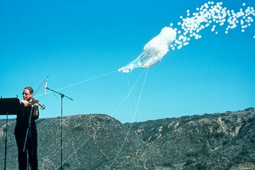 The Cloud: white balloons being released while musicians perform