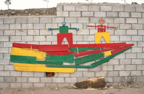 Popotla - The Wall: mural of figures on a boat