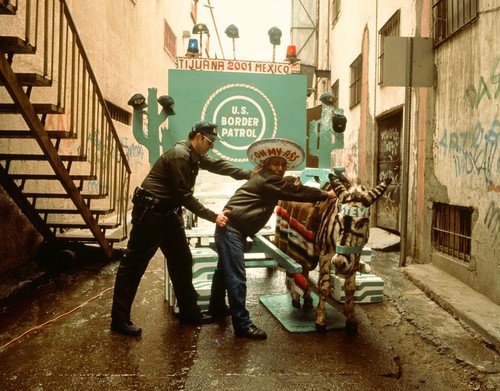 Avenida Revolución: "Street vendor" under arrest by "border patrol agent" (Meyer Vaisman)