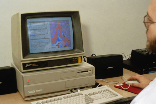 Bearded man at old computer