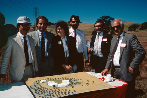 Six people standing around a model of the proposed Contra Costa Campus at the groundbreaking ceremony
