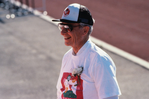 University President Ellis McCune at the track dressed in a t-shirt and baseball cap