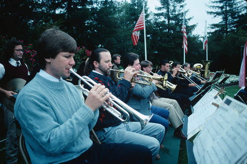 Slide of college orchestra playing during graduation ceremony