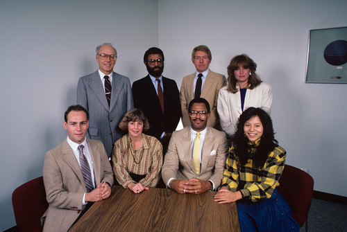 Eight people posing together