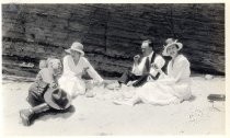Harold Elliott and three others picnicking in sand
