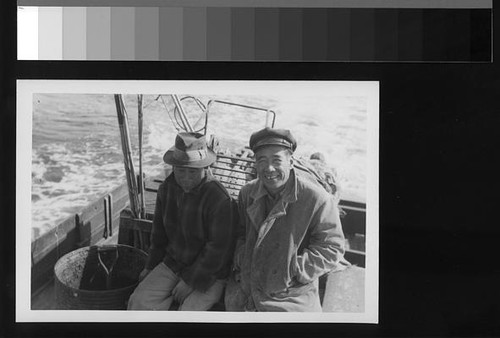 Two Japanese American men on a boat