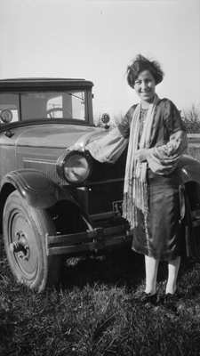 Young woman standing next to automobile