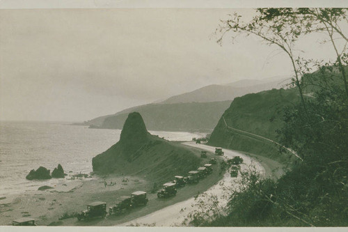 Automobiles travel south past Castle Rock and Castellammare, Pacific Palisades, Calif