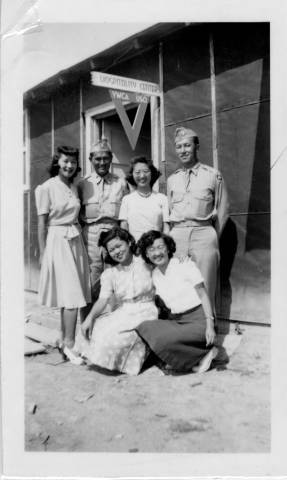 Four Japanese American women at Jerome Relocation Center welcoming two Camp Shelby soldiers at the YWCA USO Hospitality Center