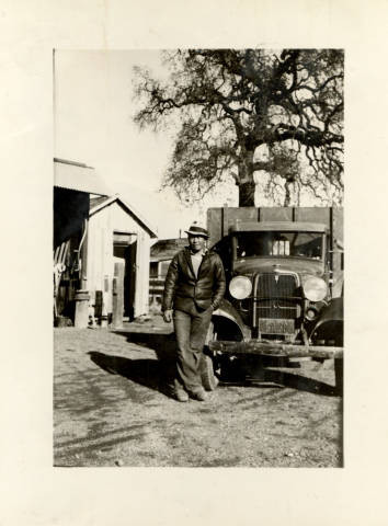 George Asato Nakano standing next to truck on family farm in Woodland