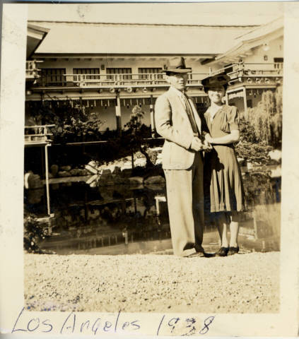 Al and Mary Tsukamoto standing in front of pond