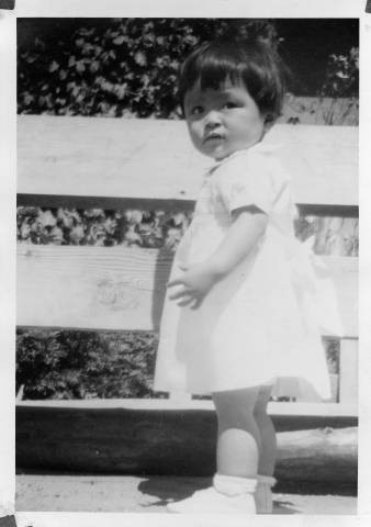 Small child standing next to fence at Granada Relocation Center