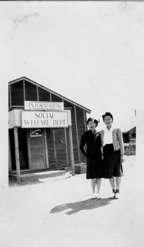 Mrs. Yasuka Akamatsu with woman outside of the Social Welfare Department at Tule Lake Relocation Center