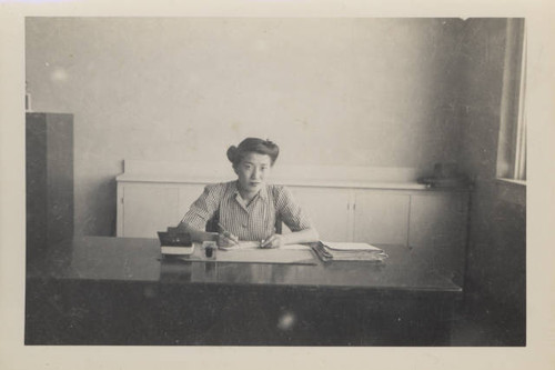 Woman at desk at Poston Relocation Center school