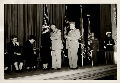 Mrs. Tsune Tahara receiving pin at Gold Star Ceremony