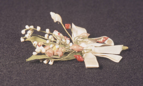 Multi-colored shell corsage pin with white ribbon
