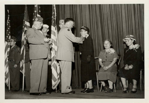 Mrs. Yoneo Hayashi receiving pin from Major General O'Sullivan at Gold Star Ceremony