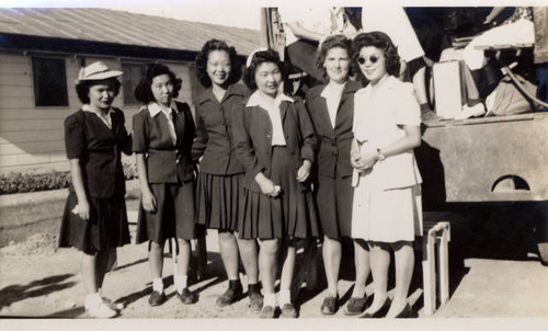 Six women standing behind truck at Poston II Relocation Center