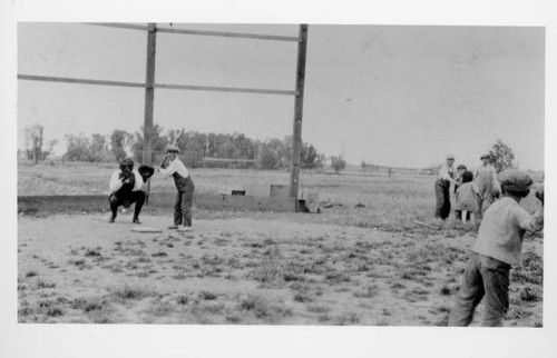 Young boys playing baseball in sandlot