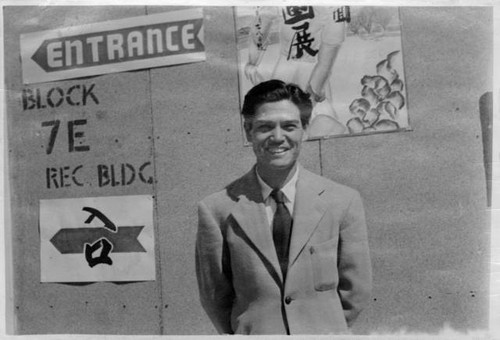 Yoshio Harry Tsuruda outside Recreation Hall for art exhibition at Granada Relocation Center