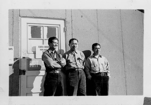 Yoshio Harry Tsuruda, Tokio Ueyama, and K. Nomiyama standing in front of Art Studio at Granada Relocation Center