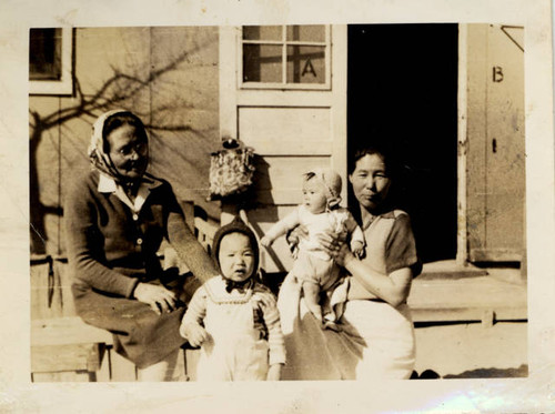 L. Misao Nakano with grandson, Alan Nakano outside barracks at Granada Relocation Center