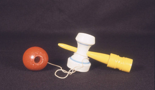 Wooden toy, ball on peg with yellow handle