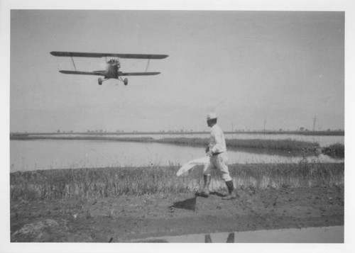 Masao Nishimi flagging crop duster plane