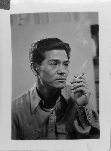 Yoshio Harry Tsuruda holding a cigarette at Granada Relocation Center