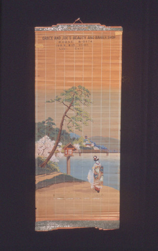 Grace and Joe's Beauty and Barber Shop promotional wall hanging with painting of woman in kimono