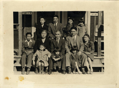 Tsukamoto family in front of barracks, block 9, at Jerome Relocation Center