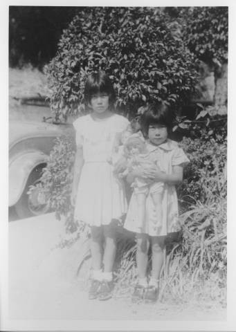 Mariko Nagumo and Reiko Nagumo holding dolls
