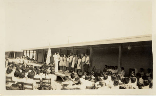 Children on stage taking pledge at Poston Relocation Center school