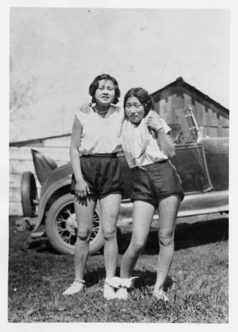 Takehara sisters in front of automobile