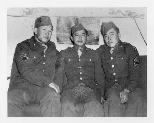 Abraham Ohama, Kaz Masuda, and Zentaro (George) Akiyama sitting on couch at training camp