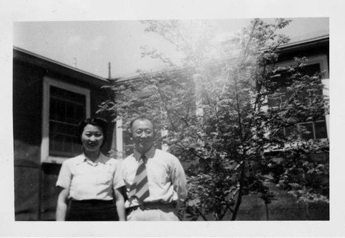 Dr. Taro Akamatsu and wife, Yasuka Akamatsu, outside the barracks at Tule Lake Relocation Center