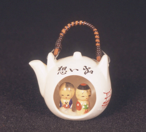 Miniture white teapot with two kokeshi dolls