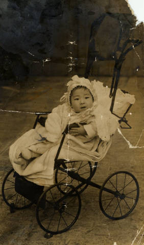 Mary Dakuzaku Tsukamoto, nine months old in a baby carriage