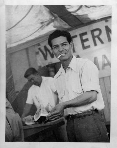 Yoshio Harry Tsuruda holding slice of watermelon at Granada Relocation Center