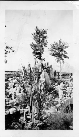 Geraldine Setsuko Nakano standing in Japanese garden at Granada Relocation Center