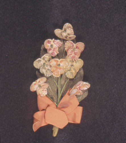 Multi-colored shell corsage pin with orange ribbon